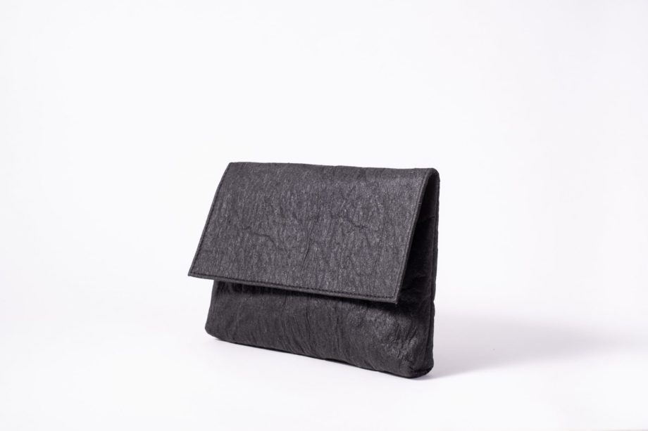 Front side view on an upstanding charcoal colored Pinatex Clutch with invisible magnet opening