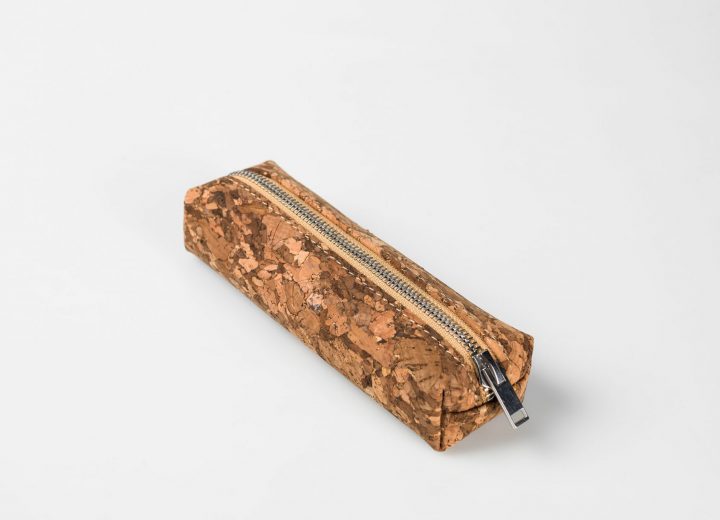 Side top view on a dark patched patterned cork pencilcase with a silver zip opening